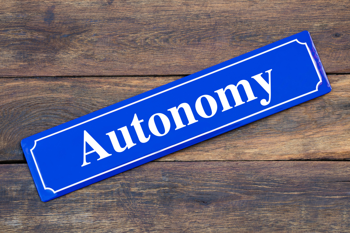 Autonomy street sign on wooden background